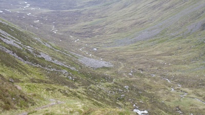The singletrack descent from Bealach Dubh next to Ben Alder. There is a rider just down and right of the large patch of scree.