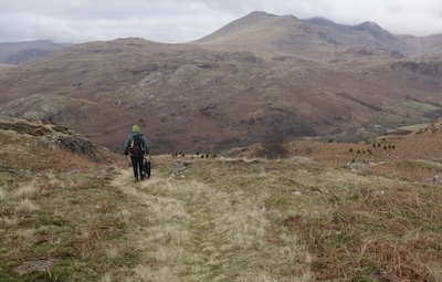 Descending back to the valley floor. Storm brewing over Scafell.